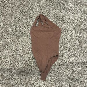 brown one shoulder body suit